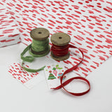 A wrapping paper in painterly patterns and red in color.
