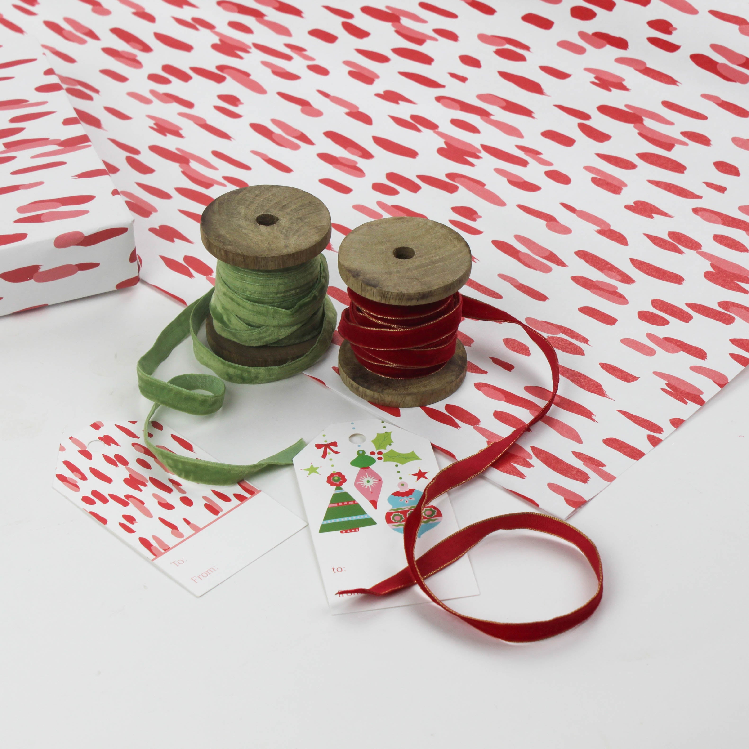 A wrapping paper in painterly patterns and red in color.