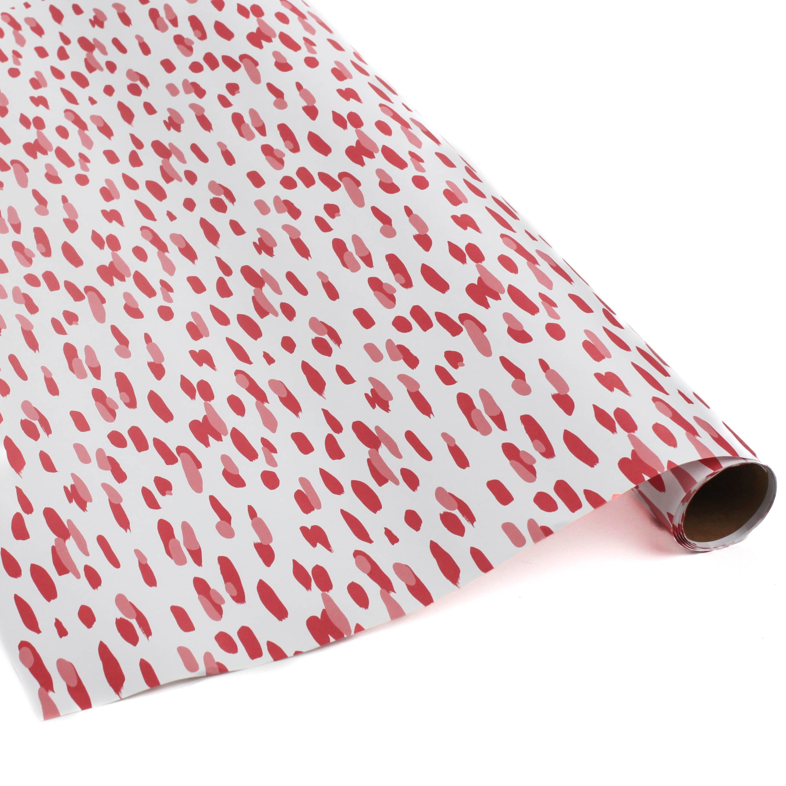 A roll of wrapping paper in painterly patterns and pink in color.