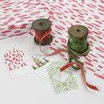 A wrapping paper in painterly patterns and pink in color.
