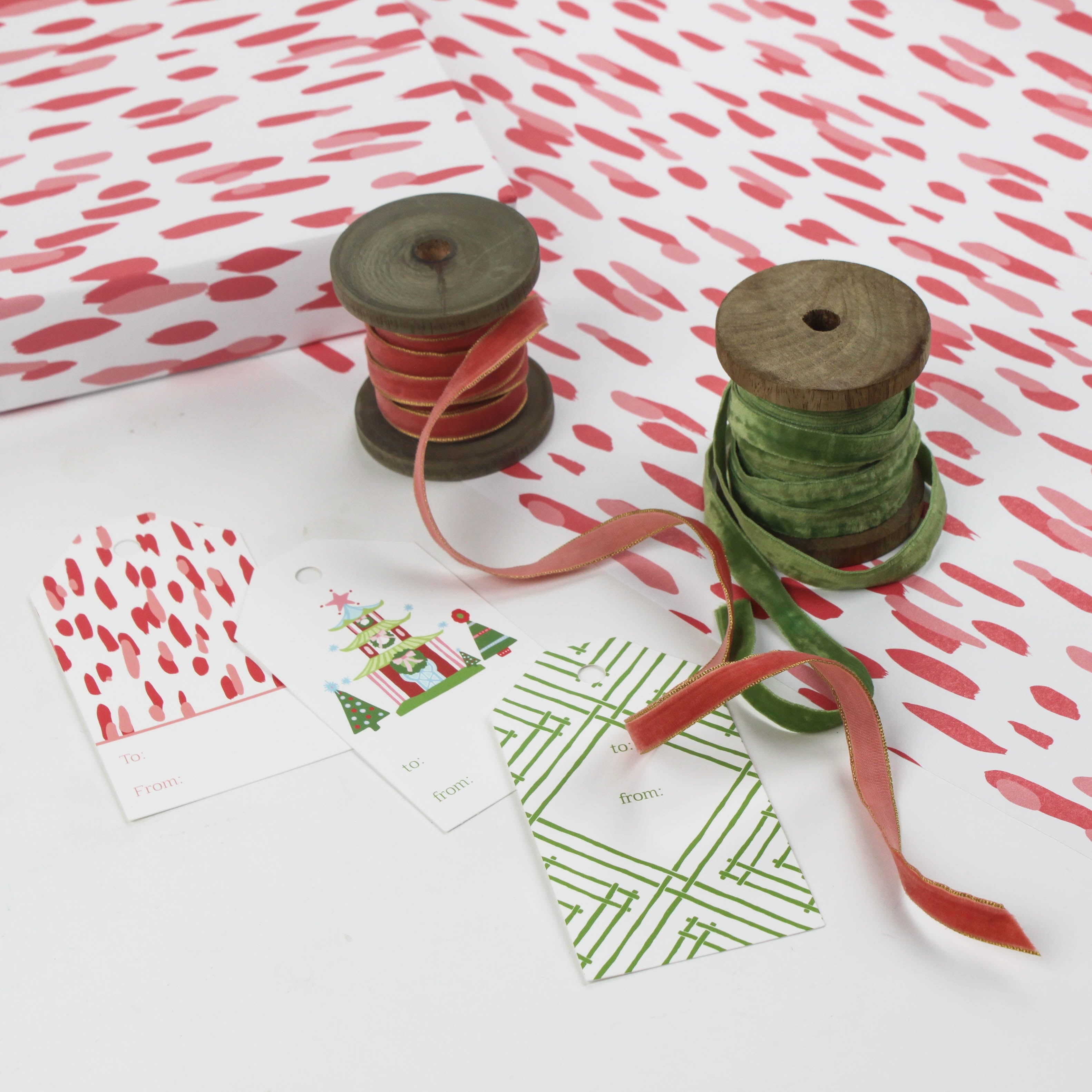 A wrapping paper in painterly patterns and pink in color.