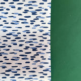 A roll of wrapping paper in painterly patterns and blue in color.