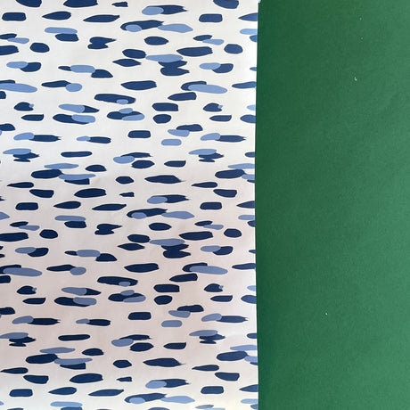 A roll of wrapping paper in painterly patterns and blue in color.