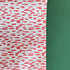 A roll of wrapping paper in painterly patterns and pink in color.