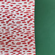 A roll of wrapping paper in painterly patterns and red in color.