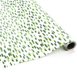 A roll of wrapping paper in painterly patterns and green in color.