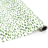 A roll of wrapping paper in painterly patterns and green in color.