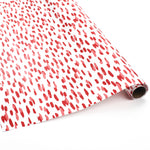 Roll of red brushstroke wrapping paper on a white background.