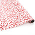 Roll of red brushstroke wrapping paper on a white background.