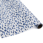 A roll of wrapping paper in painterly patterns and blue in color.