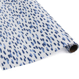A roll of wrapping paper in painterly patterns and blue in color.