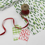 A wrapping paper in painterly patterns and green in color.