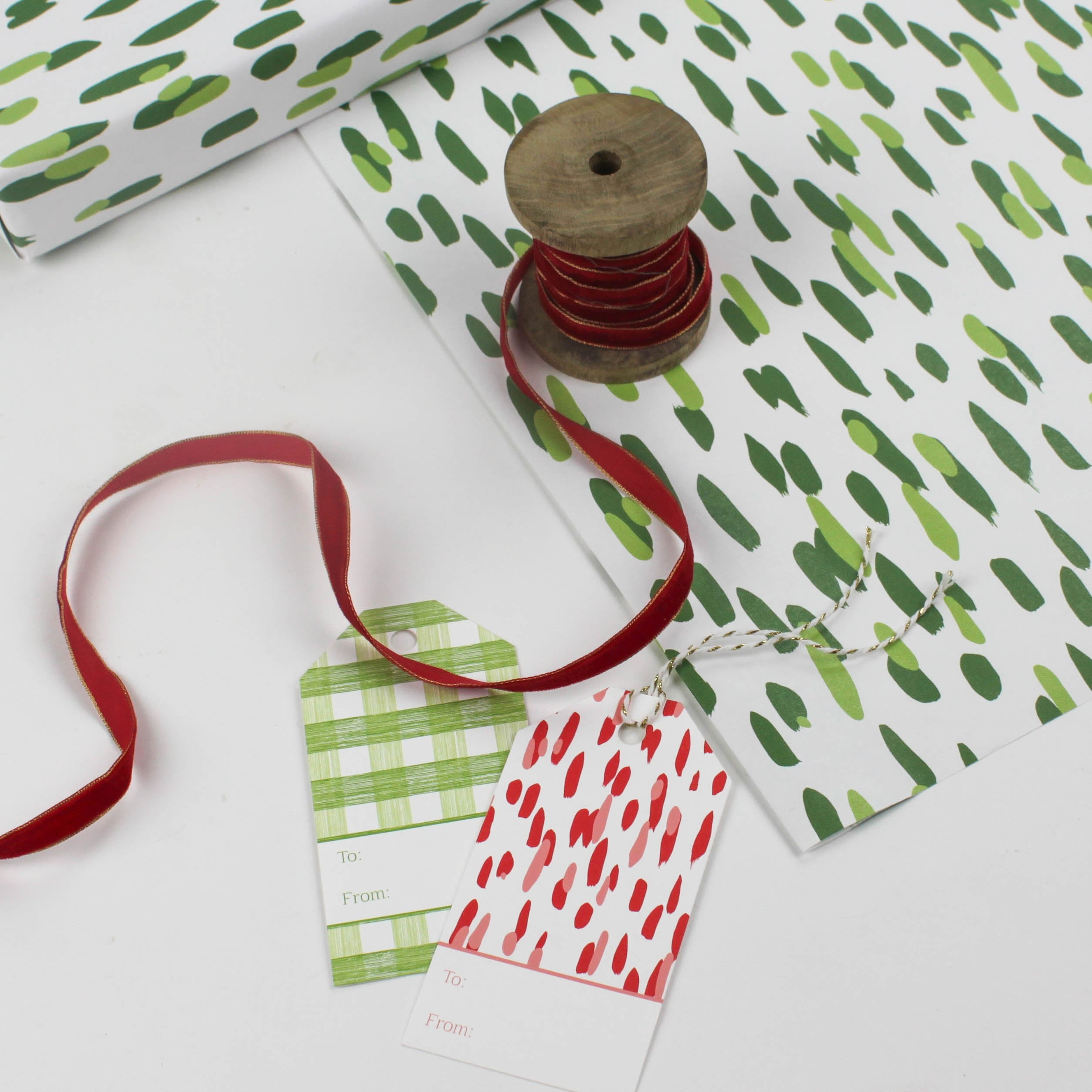 A wrapping paper in painterly patterns and green in color.