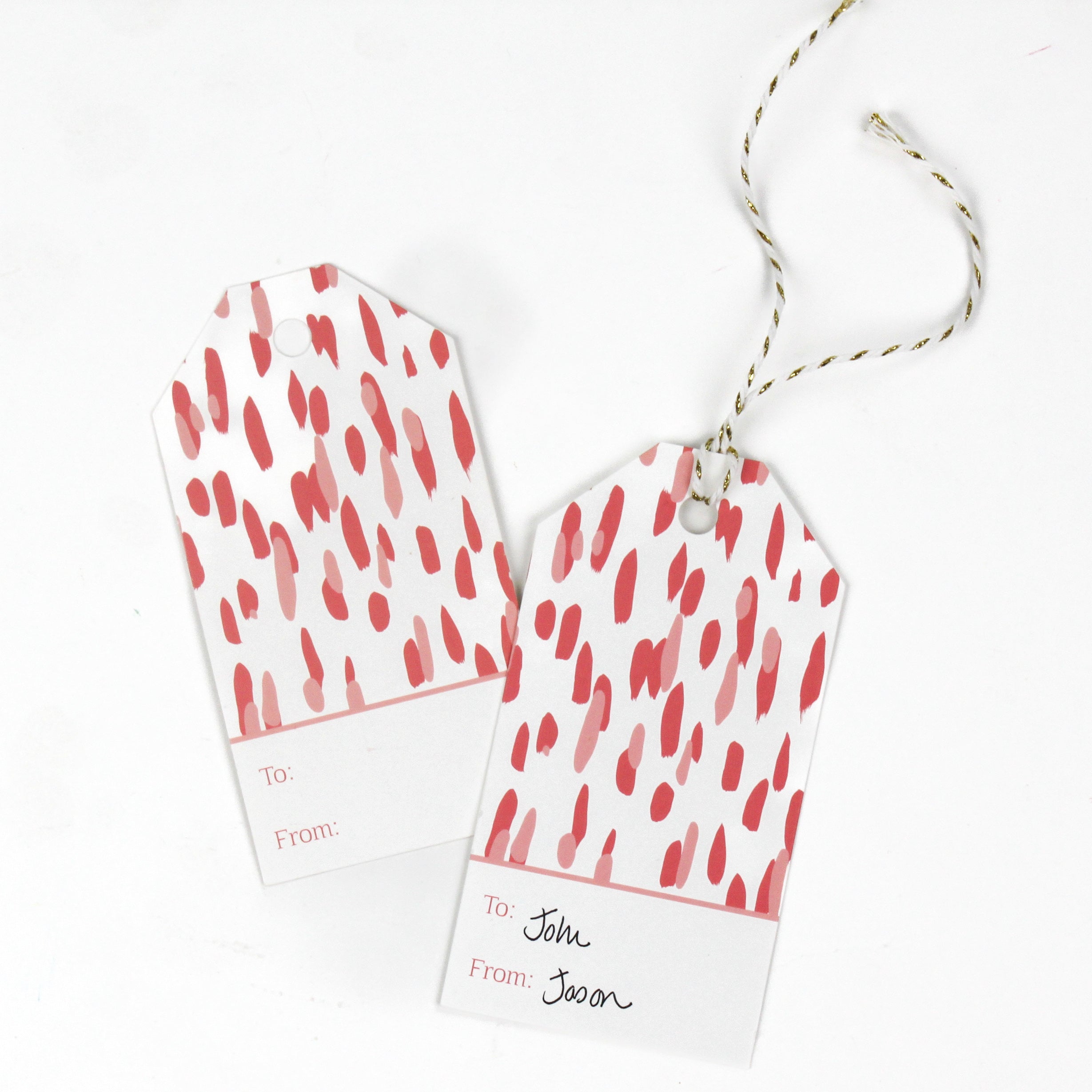 red and white gift tags with a red brushtroke pattern and a white space at the bottom that reads To: and From: