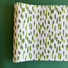 A green and white paper table runner with a brushtroke pattern
