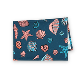 Folded coastal shell grotto tea towel with pink and turquoise seashell and starfish patterns.










Convert to PDF