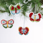 A set of four beaded butterfly felt Christmas ornaments