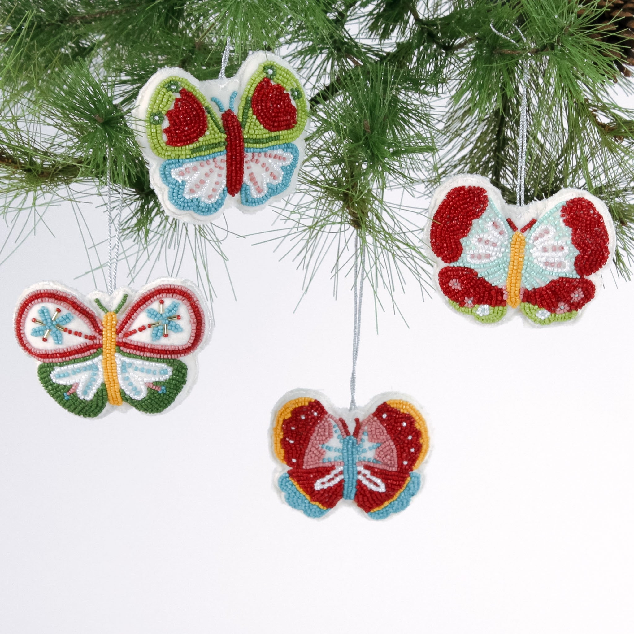 A set of four beaded butterfly felt Christmas ornaments