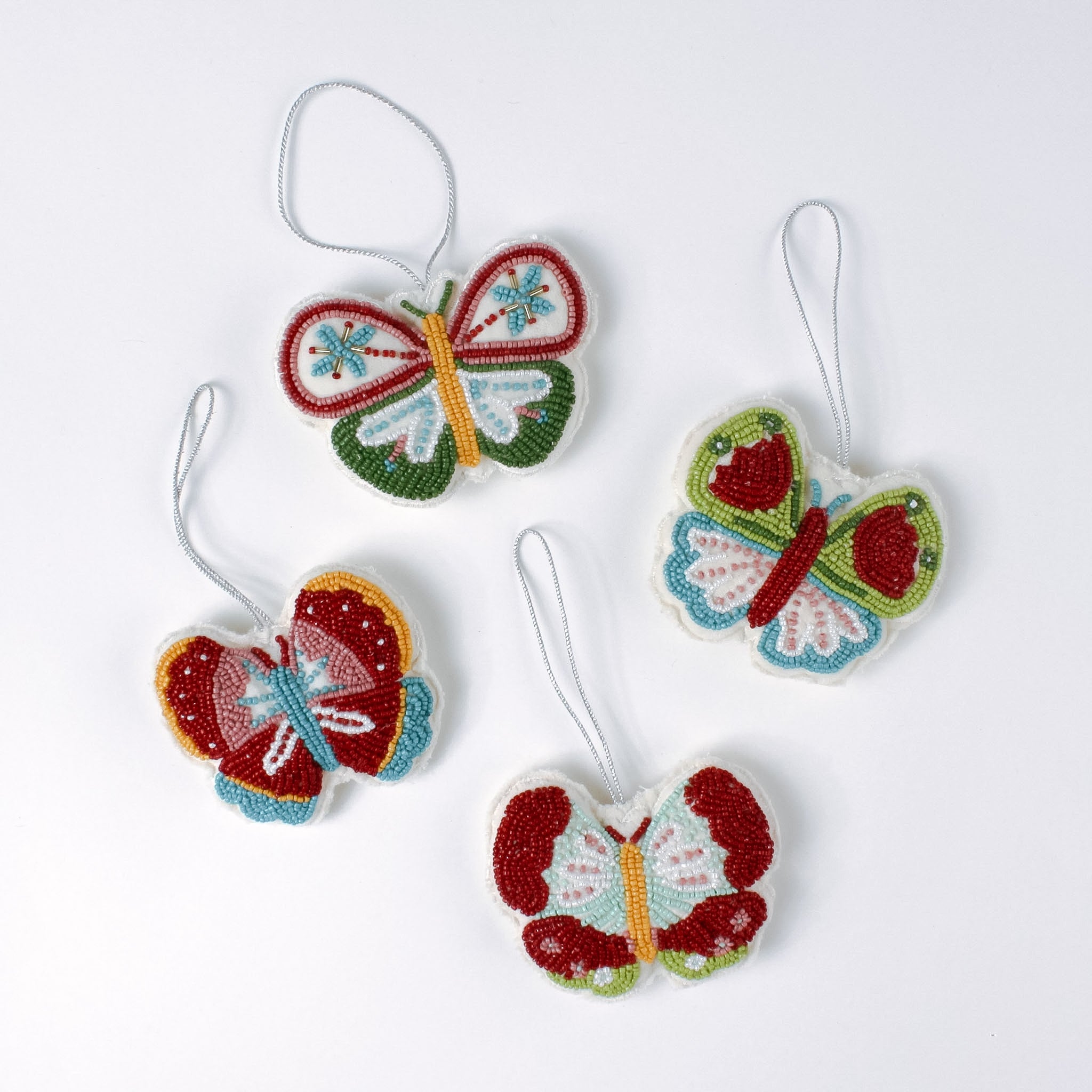 A set of four beaded butterfly felt Christmas ornaments