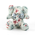 Floral patterned stuffed elephant toy with a blue and white bow.