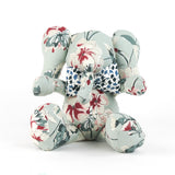 Floral patterned stuffed elephant toy with a blue and white bow.