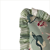 Close-up of Cottage Grove periwinkle floral pillow showing ruffled green striped trim