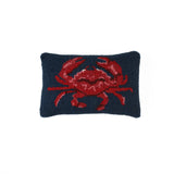 Navy pillow with a red crab design on a white background