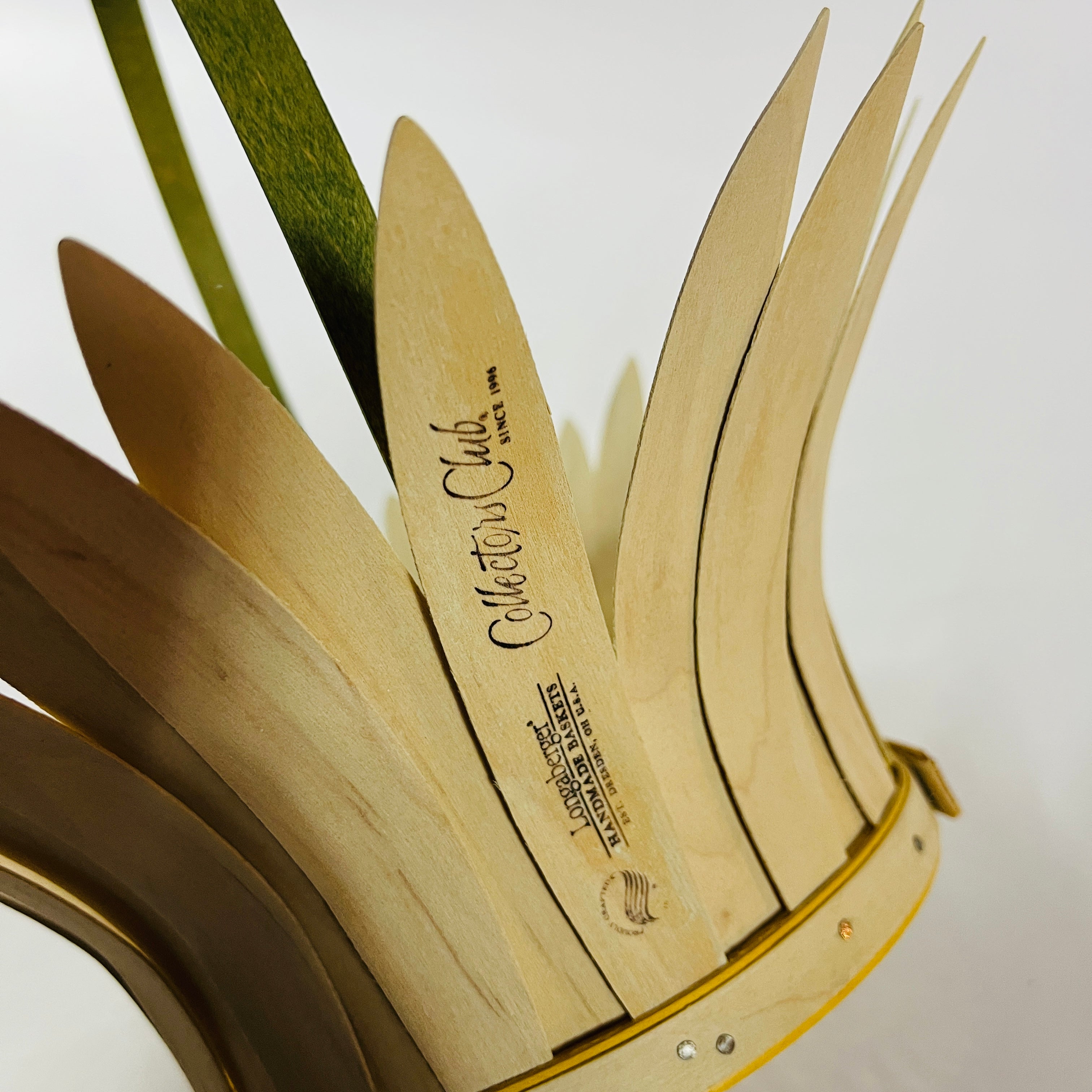 Close-up of daisy-shaped vintage wood basket showing handcrafted wooden petals and maker’s mark
