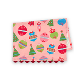 Folded Darling Ornaments Christmas cotton tea towel featuring colorful holiday ornaments, festive Christmas trees, a pink background, and red scalloped trim.