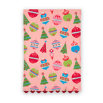 Darling Ornaments Christmas cotton tea towel featuring colorful holiday ornaments, festive Christmas trees, a pink background, and red scalloped trim.
