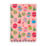 Darling Ornaments Christmas cotton tea towel featuring colorful holiday ornaments, festive Christmas trees, a pink background, and red scalloped trim.