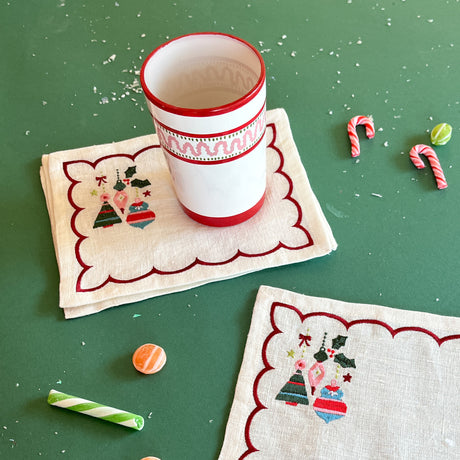 Darling Ornaments embroidered linen Christmas cocktail napkins with red striped cup.