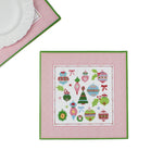 square pink paper placemats with colourful ornaments motifs in the center surrounded by a pink and green border. 