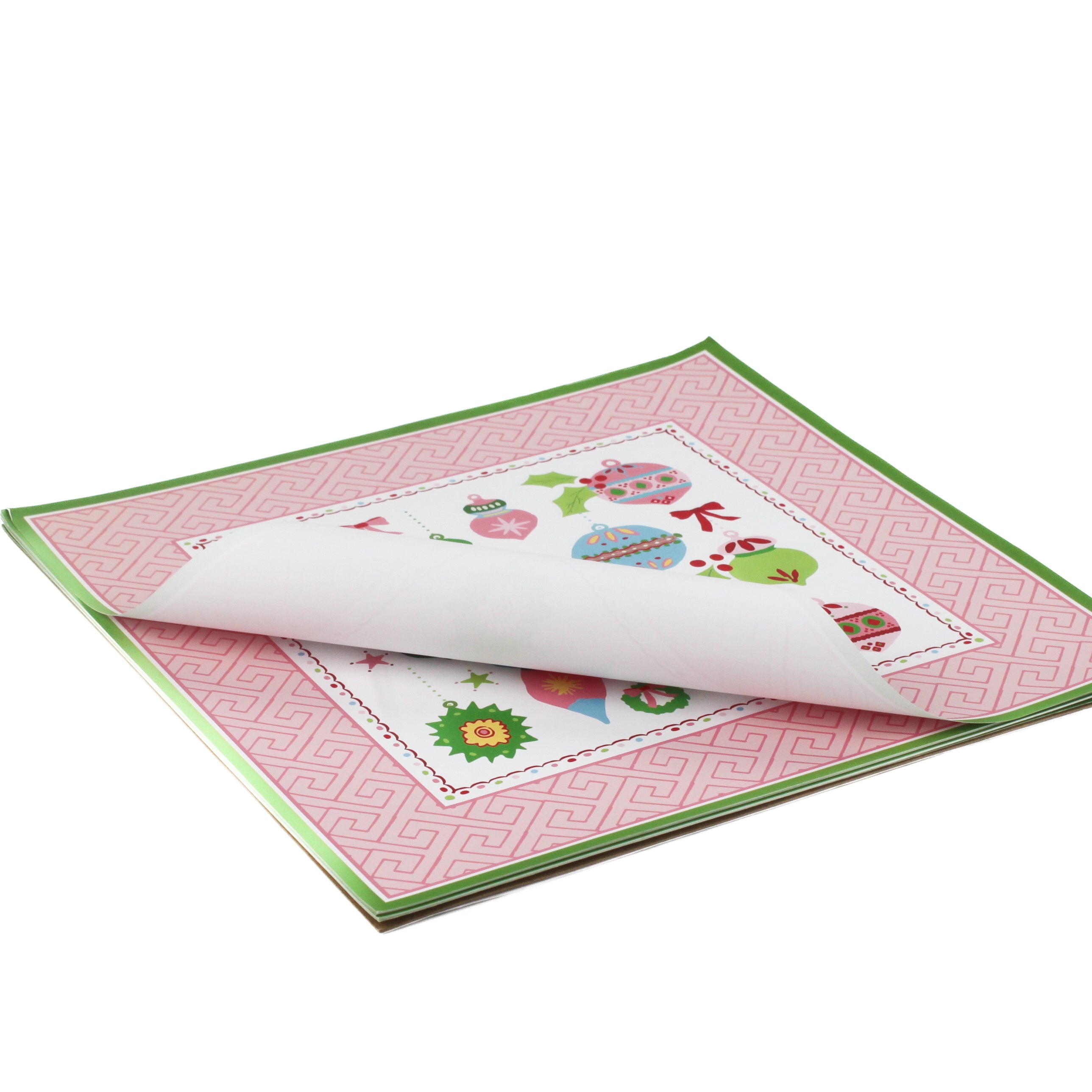 square pink paper placemats with colourful ornaments motifs in the center surrounded by a pink and green border. 