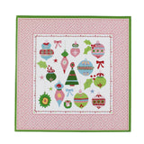 square pink paper placemats with colourful ornaments motifs in the center surrounded by a pink and green border. 