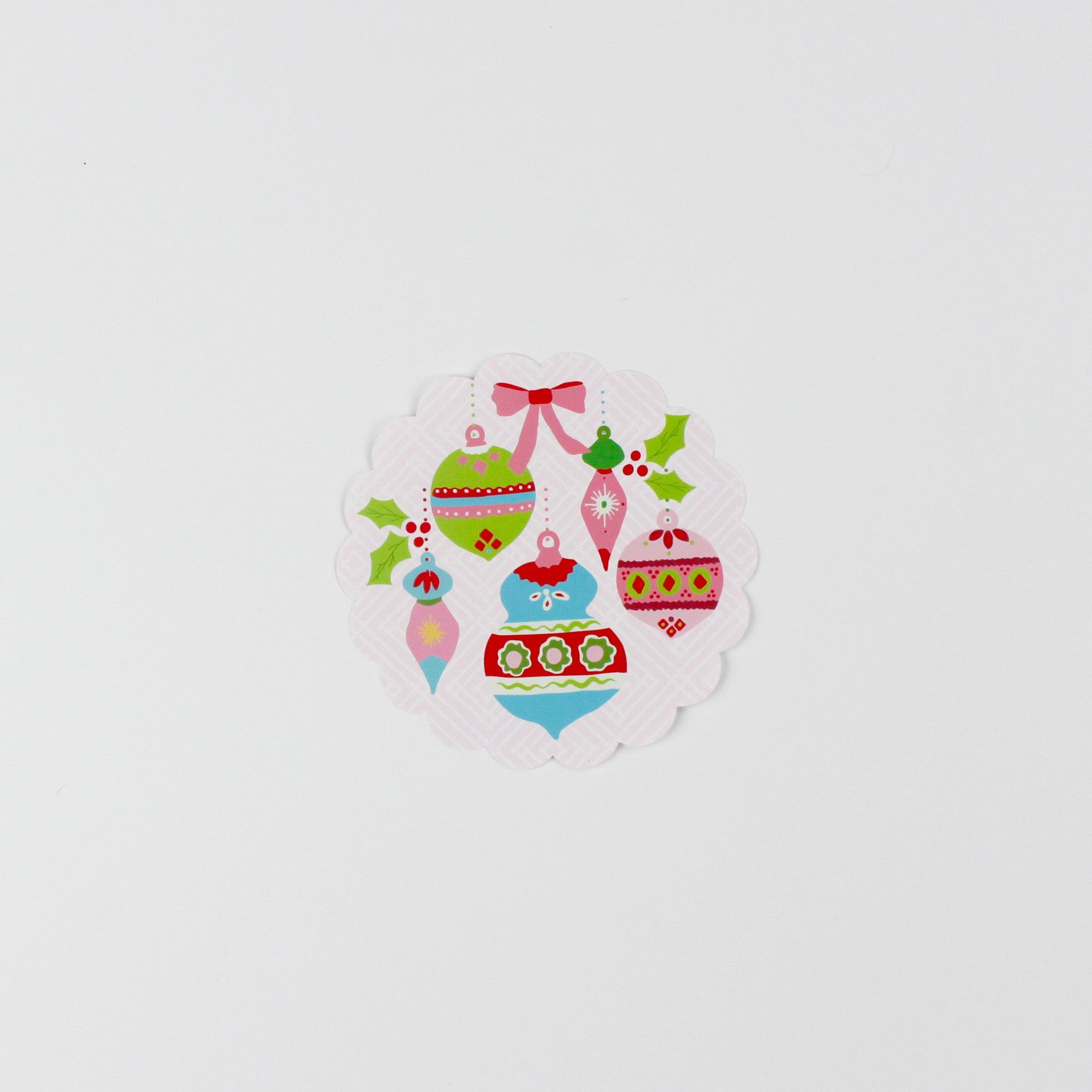 A small  round paper christmas doily with a christmas ornament pattern from Madcap Cottage. 
