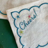 Detail of the embroidered Cheers! of Madcap Cottages linen cocktail napkin
