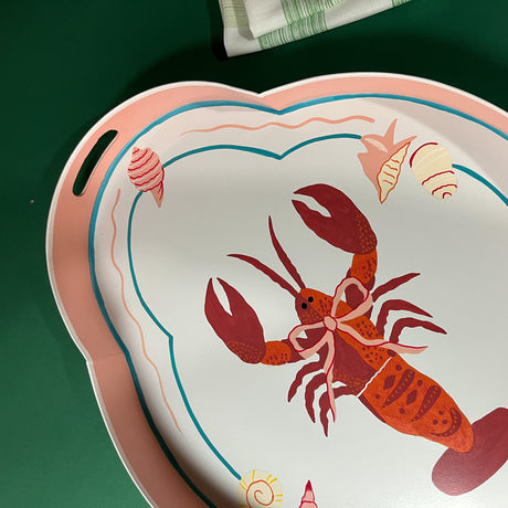 a tole metal serving tray with a rock lobster motif with cut-out handles