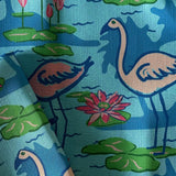 A detail view of the pattern of the Sunken Gardens Flamingo cloth dinner napkin.