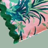 Detail image of the Jungle Road Pink cloth dinner napkin featuring a deep green ric rac trim.