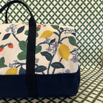 A detail view of the side/end of Strawberry Hill canvas duffel bag