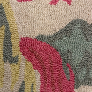 a close up of an Old Peking pink and green rug with chinoiserie motifs from madcap cottage