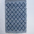 A cotton blue accent rug with a repeating diamond motif from Madcap Cottage. 