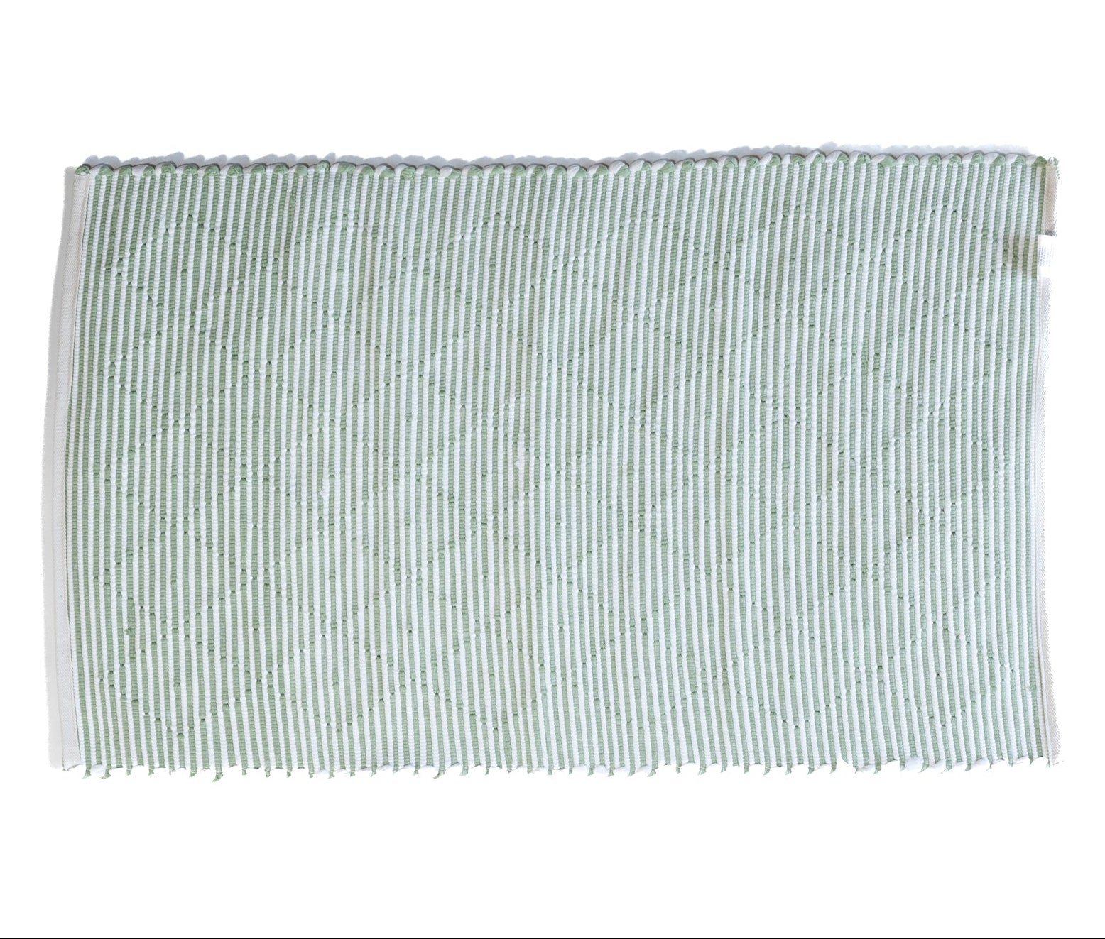 the reverse side of a cotton green accent rug 