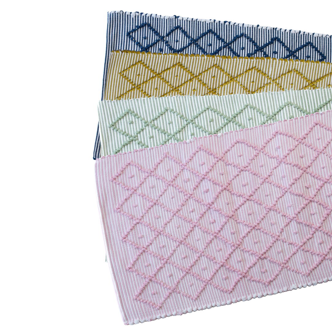 4 cotton accent rugs in blue, yellow, green and pink with a repeating diamond motif from madcap cottage