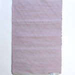 The plain reverse side of a pink accent rug from madcap cottage