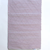The plain reverse side of a pink accent rug from madcap cottage