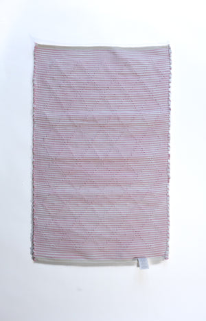 The plain reverse side of a pink accent rug from madcap cottage