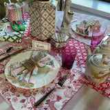 Tablescape of East of the Sun red chinoiserie placemat with Asian themed porcelainware.