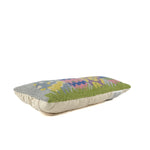 rectangular hooked pillow with colorful Easter eggs and grass design